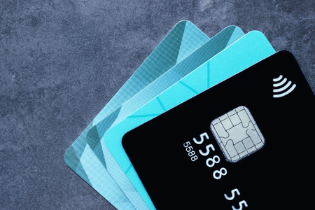 Multiple credit cards on a dark background. Selective focus. Concept - Finance, business, cashless payment.の写真素材