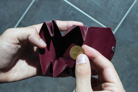 One coin in the little purse. Concept -   poverty, expenditure, savings, shopping.の写真素材