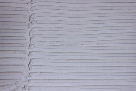 Tile adhesive notched trowel patterns. Adhesive background. 