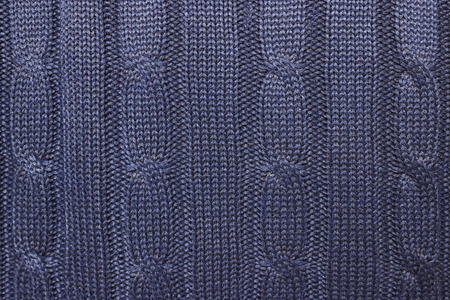 Knitted woolen texture. Dark blue sweater with a large weave.  Background.
