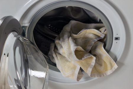 Clothing in washing machine.  Concept- laundry, housework, house cleaning.の写真素材