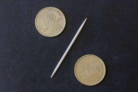 Percentage sign made out of coins.  Greek drachma. Concept of debt.