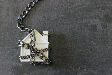 House in chains. Concept  -  risks, lose property,  seize, mortgage.の写真素材