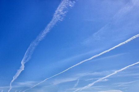 Trace of the plane in the blue sky. Sunny day. Greece. Concept- travel, vacation,  geoengineering...