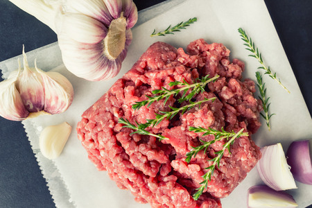 Raw minced meat with thyme and spices for cooking cutlets, hamburgers, meatballs. Concept- cooking,...