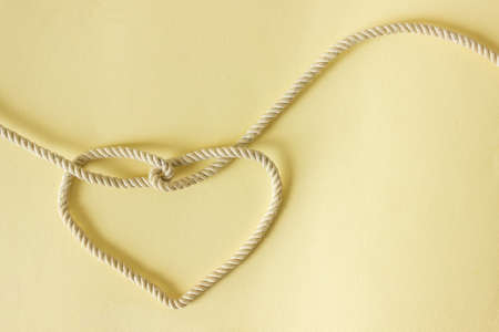 A heart shaped knot made of white rope. Love concept.の写真素材