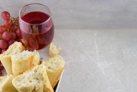 Golden Fresh Baked Bread and Delicious Red Wine Atop a Stone Background with Space for Textの写真素材