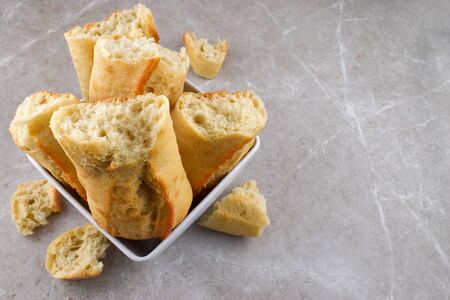 French Bread in a Square Shaped Bowl Served Fresh on a Gray Stone Background. Features Space for Text.の写真素材