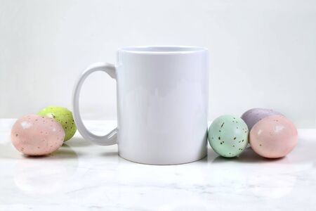 11 oz. White Coffee Mug Mockup with Colorful Speckled Easter Eggsの写真素材