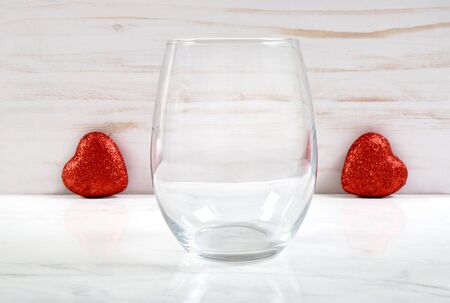 No Stem Wine Glass Mockup with Red Valentine Heartsの写真素材