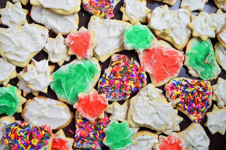 A pile of fresh baked Christmas cookies resting merrily on a wooden table. の写真素材