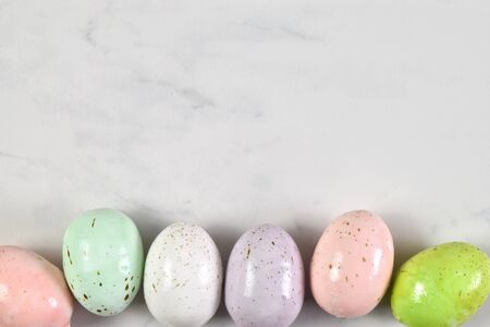 Beautiful speckled Easter eggs atop a marble background with plenty of room for copy space.