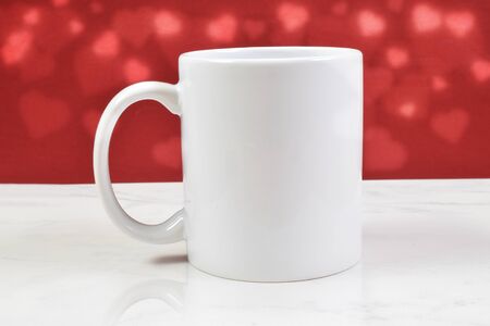 An 11 ounce white coffee cup sits sweetly on a classy white marbleの写真素材