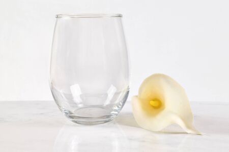 This Easter inspired mock up features a stemless wineglass next to a lovely white calla lily. の写真素材