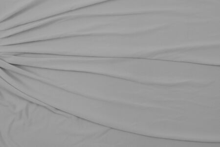 Top down view of light gray flowing fabric. Plenty of room for copy in this elegant background texture.の写真素材