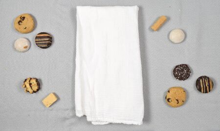 Top down view of white tea towel surrounded by delicious cookies.の写真素材