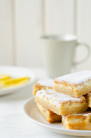lemon bars on a white plate with slicesの写真素材
