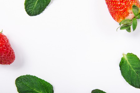 Strawberries and mint. Top view, background. Bright red ripe berry with leaves of green mintの写真素材