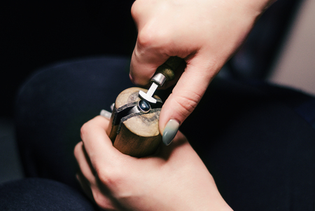 The master creates a texture on the jewelery in the workshop. Knockout pattern, handmade.の写真素材
