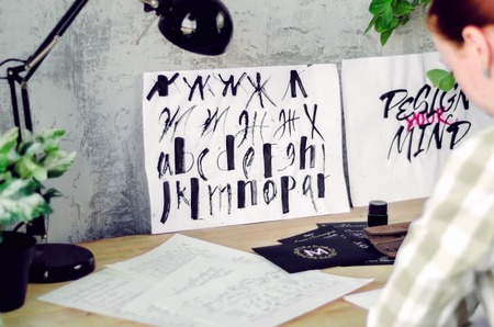 Calligraphic drawings with watercolor on the calligraphers desktop. Tools and works of the artist.の写真素材