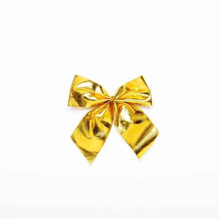 Golden bow, Christmas tree toy for Christmas tree. Top view, flat lay. Concept of the holiday.の写真素材