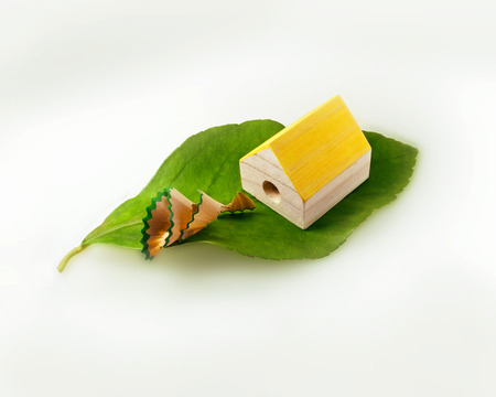 Eco house. Alternative zero emission energy concept with house shaped pencil sharpener. Emission of clean wasteの写真素材