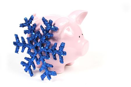 Pink Piggy Bank on isoalted on white background with blue snowflakeの写真素材