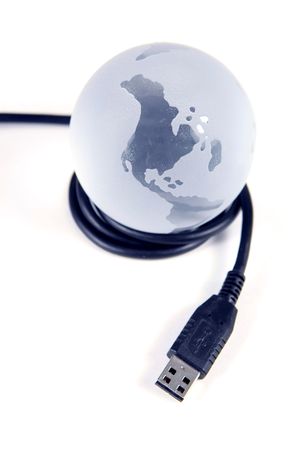Glass globe with USB cable on white backgroundの写真素材
