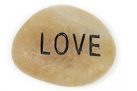 Love word engraved on stone with white backgroundの写真素材