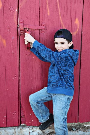 Young child hanging out near a grungy wall の写真素材
