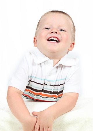 Little boy posing with smile on whiteの写真素材