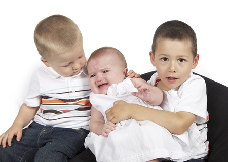 Children posing for family photo together on whiteの写真素材