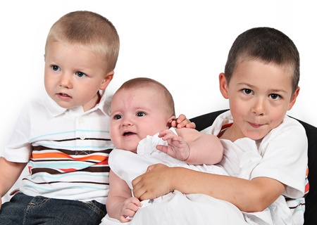 Children posing for family photo together on whiteの写真素材