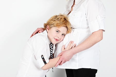 Cute little boy and mother posing for camera on white backgroundの写真素材