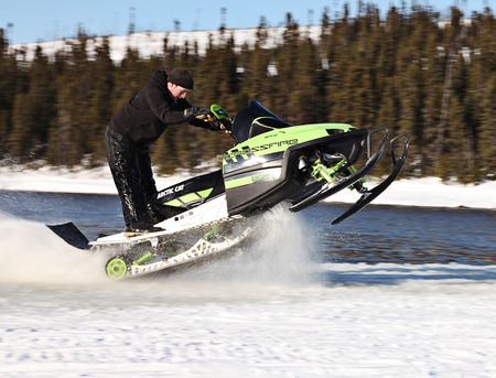 Man riding snowmobile in winterのeditorial素材