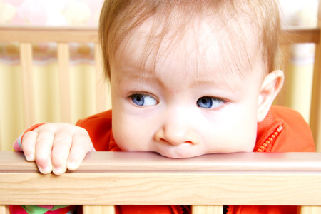 Little Baby Bitting on cribの写真素材