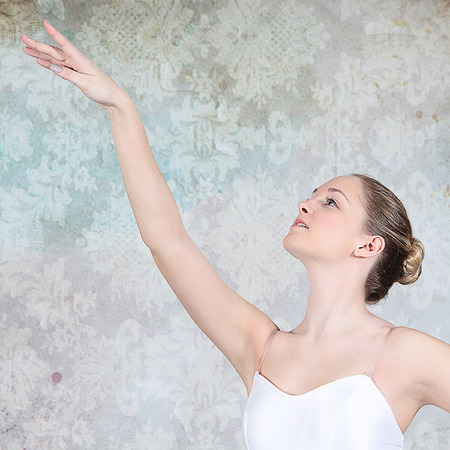 Ballerina dancing in studio with multicolor backgroundの写真素材