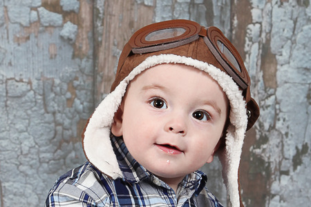 Cute little boy posing for camera on white background