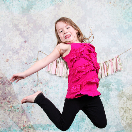 Adorable little girl isolated on white background Jumping