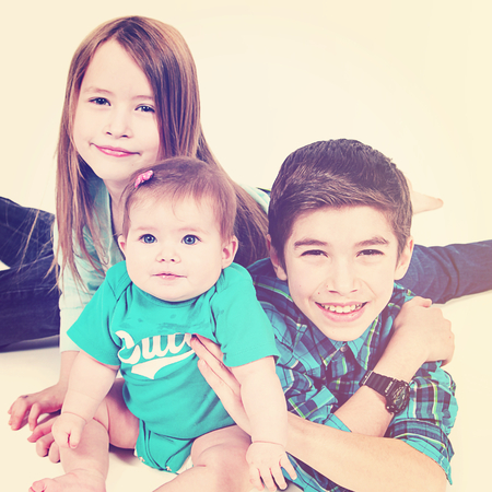 Adorable little brother and Sister on studio background
