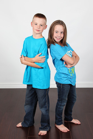 Twin brother and sister posing together in studioの写真素材
