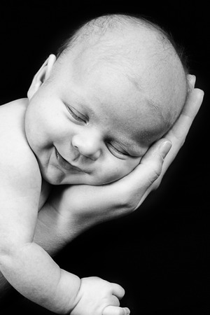 Newborn Baby taken closeup in mother's Handの写真素材