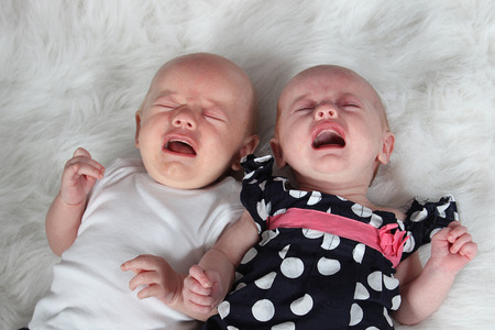 Adorable little brother and Sister on studio background