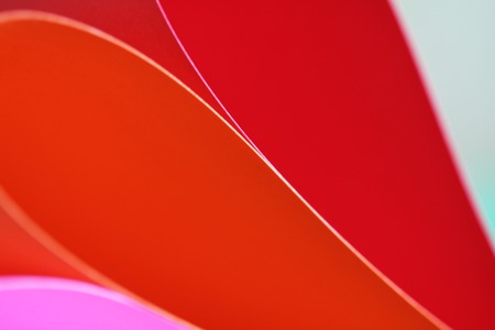 Abstract paper stack defocused colourful background. Paper stack of different colors defocused