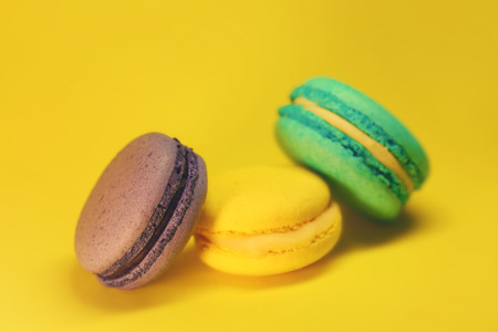 Bright food photography of macroons on yellow backgroundの写真素材