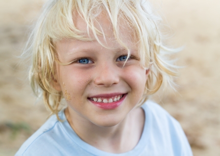 Portrait of a handsome and happy boy enjoying a day at the beachの写真素材