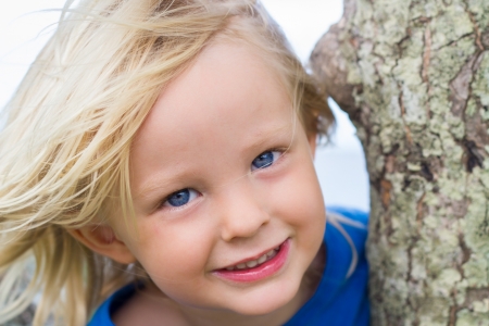 Close-up portrait of a happy young child at the beach の写真素材