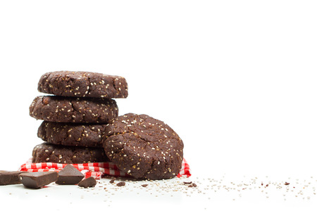 Stack of healthy dark chocolate chia seed cookies with ingredientsの写真素材