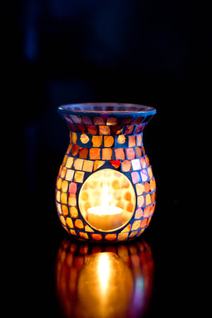 The warmth from this oil burner can be seen and felt from the tones in this capture along with the striking colours of the glass mosaic tiles の写真素材