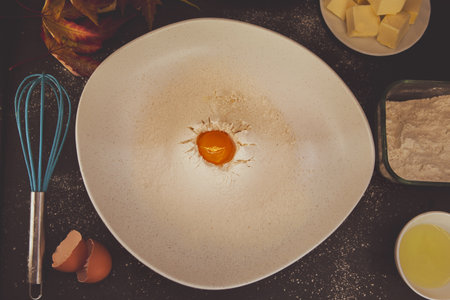 Autumn-inspired roast in preparation â seasonal ingredients with warm fall tones and scattered autumn leaves evoke cozy harvest cooking.の写真素材